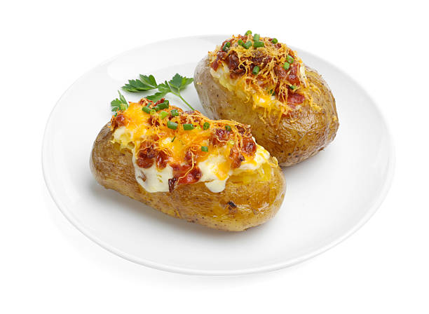istock Tasty baked potatoes with stuffing isolated on white 2248419163