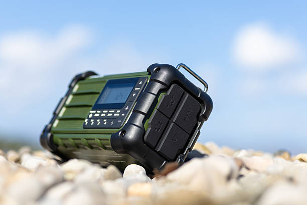 Rugged Handheld Radio With Digital Display On Pebble Ground For Fieldwork