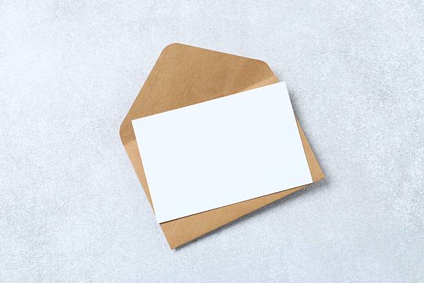 istock Paper card wit craft evelope on marble. Perfect for wedding invitations, event announcements, or branding for women. 2248421035