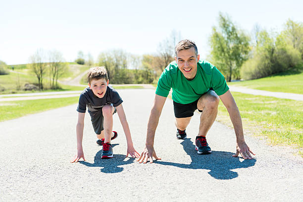 Father preparing his son to run. Copy space.