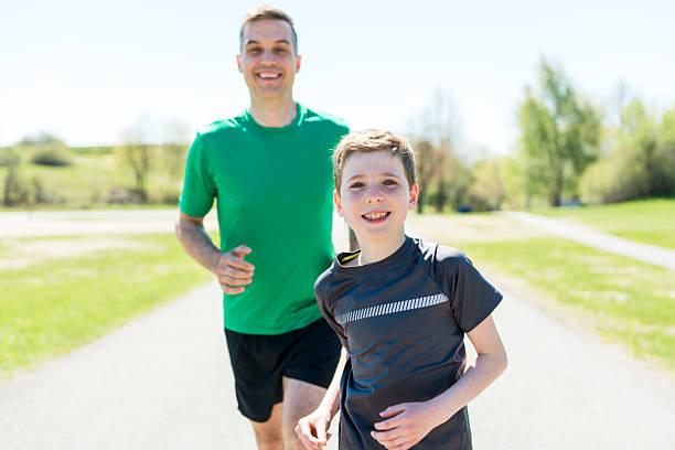 A father with son sport running together outside