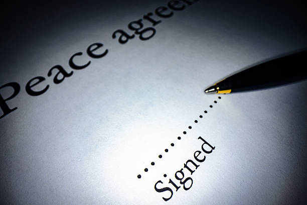 Peace deal, agreement, document close up with pen.