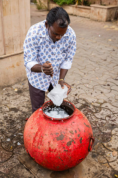 istock Ice vendor chiseling ice blocks — Jaipur, India 2248424356