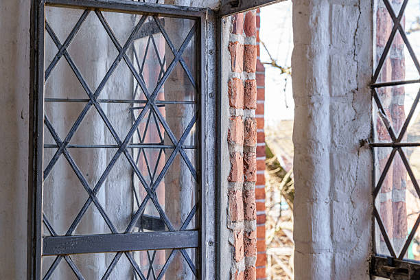 A window with a brick wall behind it in Lubeck Germany. The window is open and the brick wall is visible