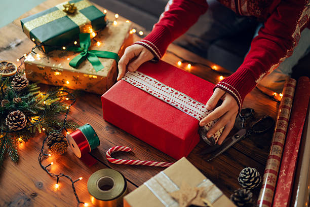 istock Woman wrapping and decorating Christmas presents. 2248427820