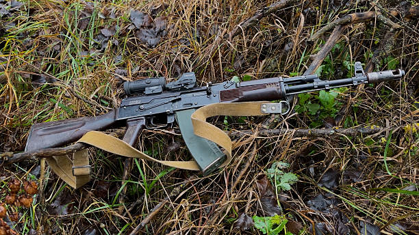 istock A Kalashnikov assault rifle lies on the grass in the forest. 2248429676