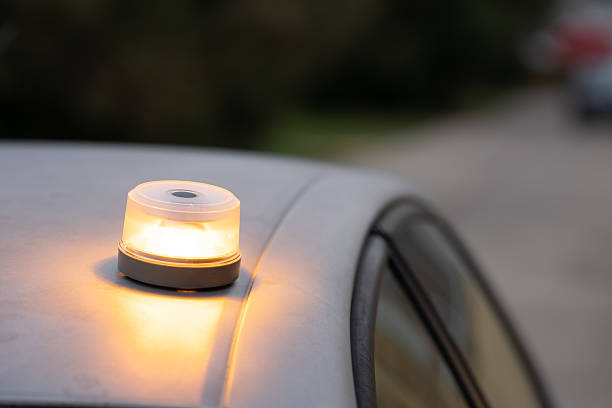 istock Car breakdown warning light flashing on roadside, v16 beacon, baliza v16 2248430718