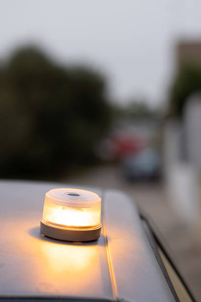 istock Emergency warning light flashing on car roof at roadside, v16 beacon, baliza v16 2248430723