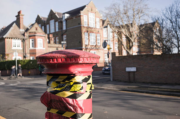 istock Red Postbox Wrapped in Hazard Tape on a London Street 2248432256