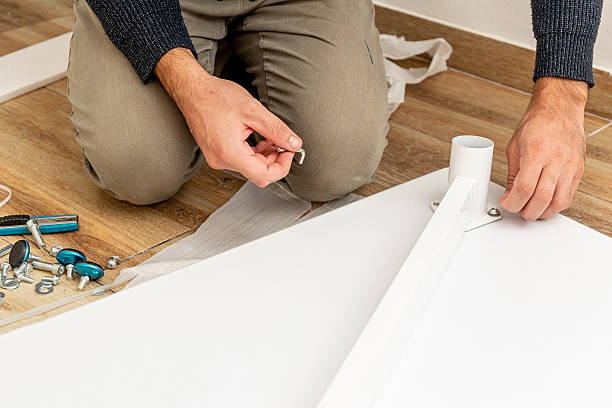 istock Man handyman furniture assembler assemble table with hand screwdriver and screws 2248433539