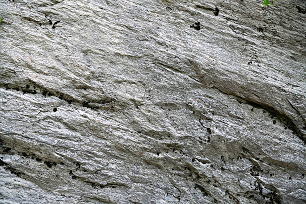 Mining cliff of rough rock cras. Texture of mountain grey stone with high resolution.