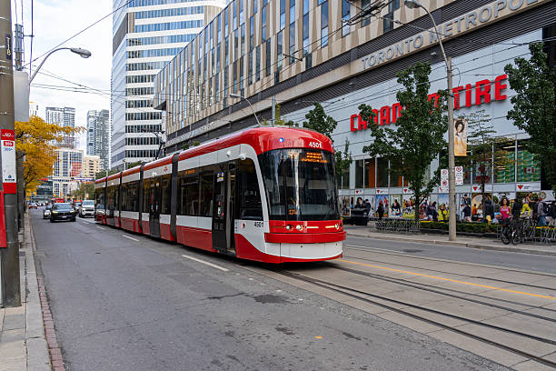 Toronto, ON, Canada - November 8, 2025: A red streetcar is seen in downtown Toronto, ON, Canada. The Toronto streetcar system is a network in Toronto operated by TTC.
