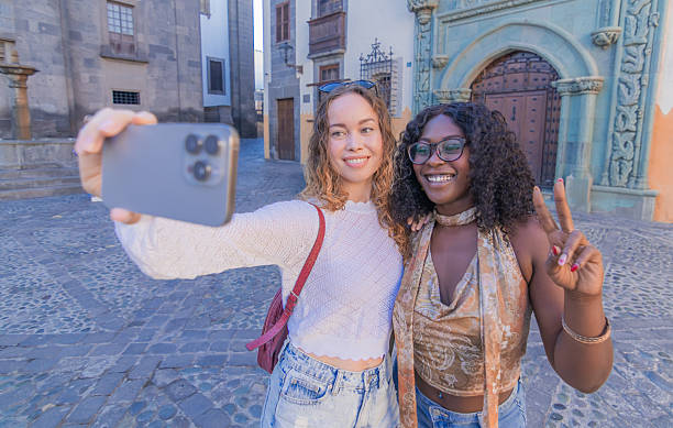 istock Happy friends take a selfie while walking around the city 2248436334