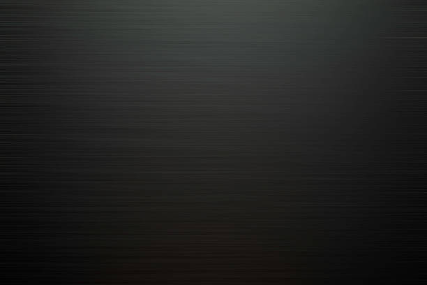 Extreme close-up of black pleated fabric abstract background.