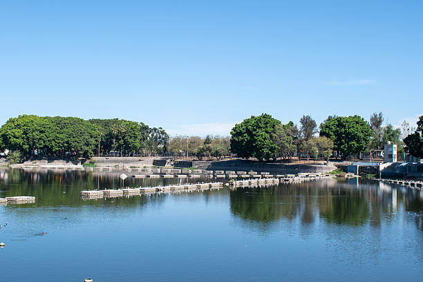 Concrete structures over the reflective lake at Parque Independencia El Dean
