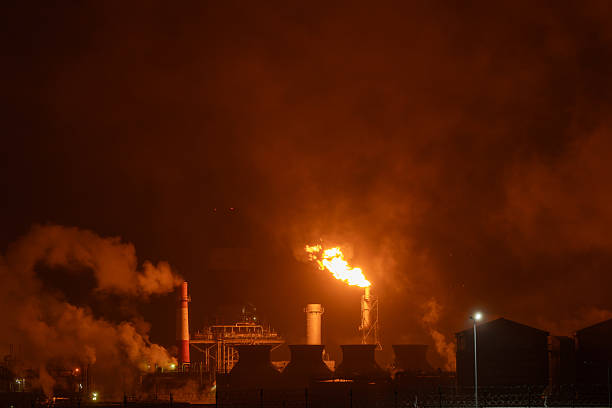 istock An industrial flare stack burns off excess gas with a large, bright orange flame and thick smoke 2248439455