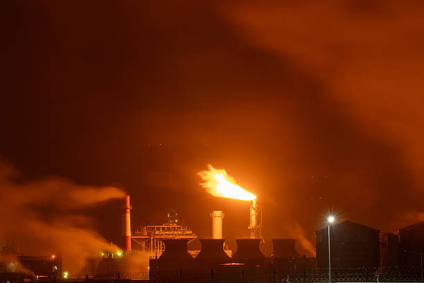 istock An industrial flare stack burns off excess gas with a large, bright orange flame and thick smoke 2248439457
