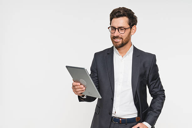 istock Businessman, confident and tablet for internet in studio on white background for startup company as salesman. Corporate, entrepreneur and browse online or website to network, search for opportunity 2248440476