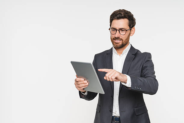 istock Business man with tablet, technology or corporate communication isolated on studio background. Internet, connectivity or networking professional, male worker or check email for career on mockup space 2248440483