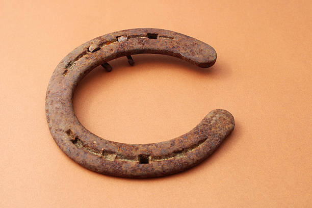 rusty iron horse shoe on the wooden background