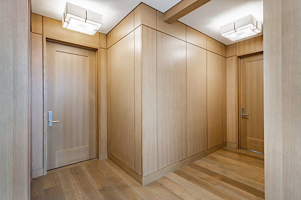 istock Expansive hallway entry foyer with stone pillars herringbone wood flooring windows and long view 2248440983