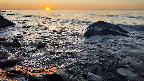 istock Rocky Shore Waves At Tranquil Ocean Sunset 2248442123