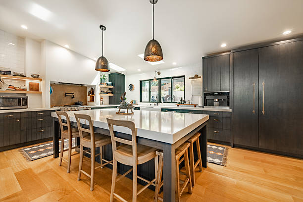 istock Kitchen interior in a bohemian style with blue cabinets island small appliances and stainless appliances bright with large window over sink 2248444836