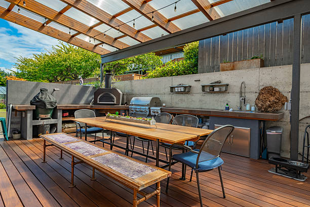 istock Stunning outdoor living area with kitchen dining table and chairs seating area fireplace hammock covered patio and pass through to home interior 2248444863