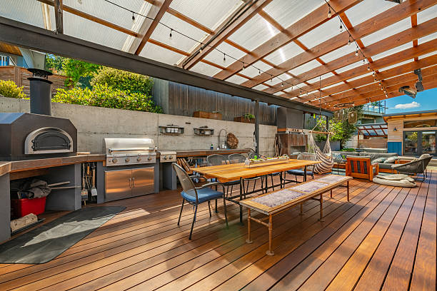 istock Stunning outdoor living area with kitchen dining table and chairs seating area fireplace hammock covered patio and pass through to home interior 2248444864