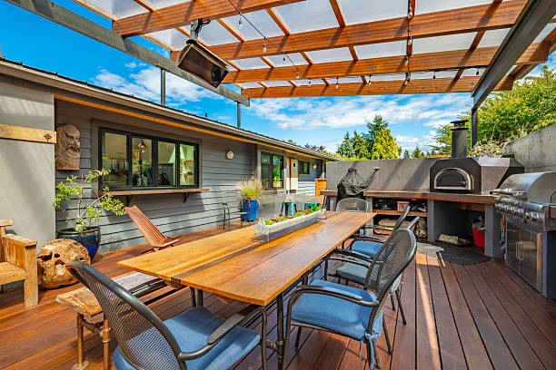istock Stunning outdoor living area with kitchen dining table and chairs seating area fireplace hammock covered patio and pass through to home interior 2248444871