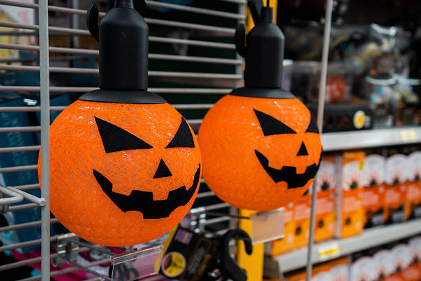 istock Halloween decoration hanging on display, orange pumpkin with face, shopping. 2248446997