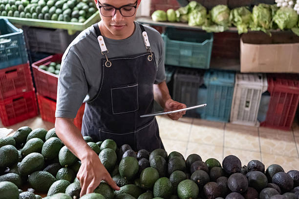 avocado seller at the fruit and vegetable market
