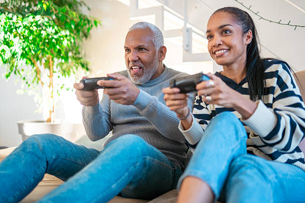 istock Mature Hispanic Couple Playing Video Games in Cozy Home Setting 2248448247
