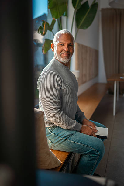 istock Mature Hispanic Man in Grey Sweater Sitting by Window 2248448257