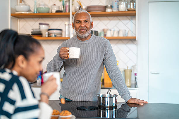 istock Mature Hispanic Man Enjoying Morning Tea in Bright Modern Kitchen 2248448348