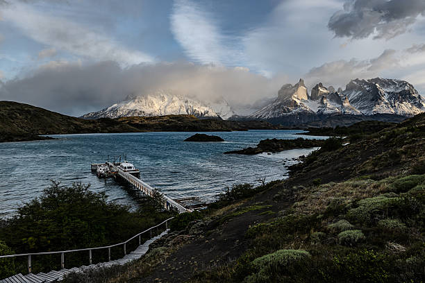 A view of  a boat dock on Pehoe Lake and Torres Del Paine, including the Paine Massif