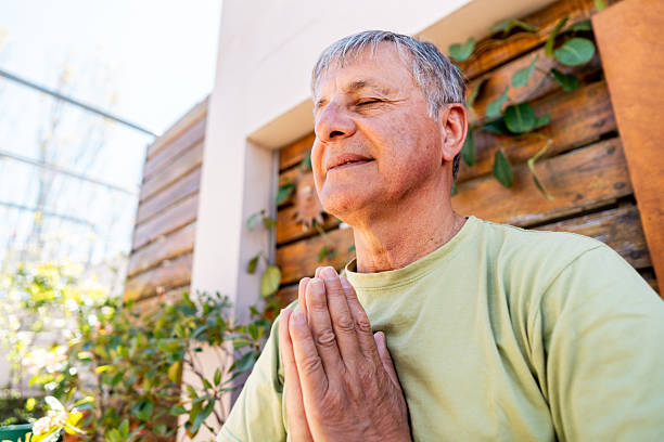 Senior man doing yoga outdoors