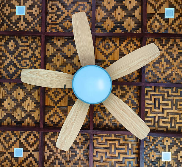 Residential ceiling fan in motion on a white ceiling.