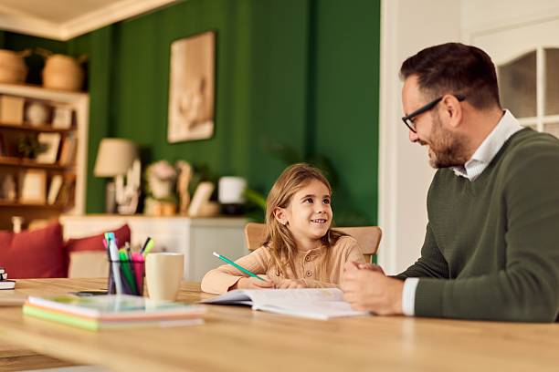 istock Father Helps Daughter With Homework At Cozy Home Table During Positive Study Time 2248451918