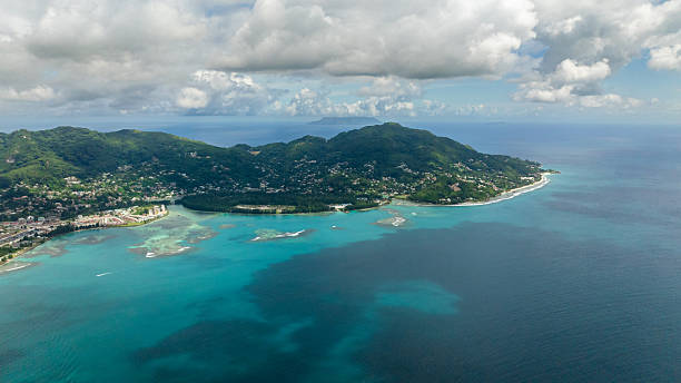 istock Lush green coastal hill with turquoise waters. Seychelles, Mahe. 2248452586