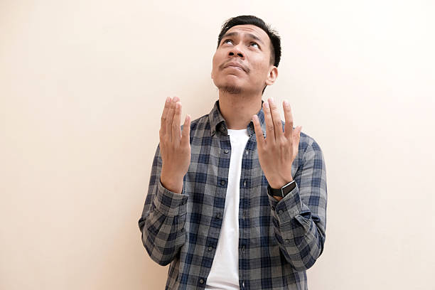 istock A Southeast Asian man looks above, he gesture of hope with a desperate expression 2248453363