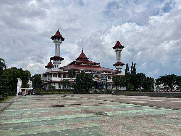istock Grand Mosque of Cianjur, West Java, Indonesia, featuring distinctive architecture, twin minarets, and reflective courtyard pool under a cloudy sky. 2248454484
