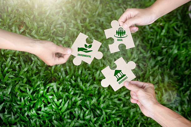 istock A concept image showing hands holding ESG puzzle pieces representing environmental, social, and governance sustainability. Ideal for corporate responsibility, green business strategy, and ethical investment themes. 2248463025