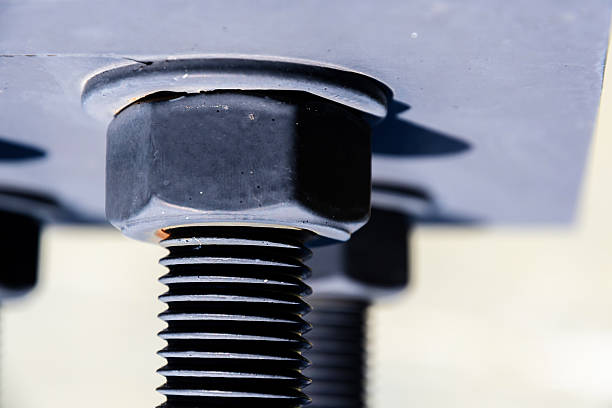 istock Large industrial bolt secured with a nut to a metal plate 2248465076