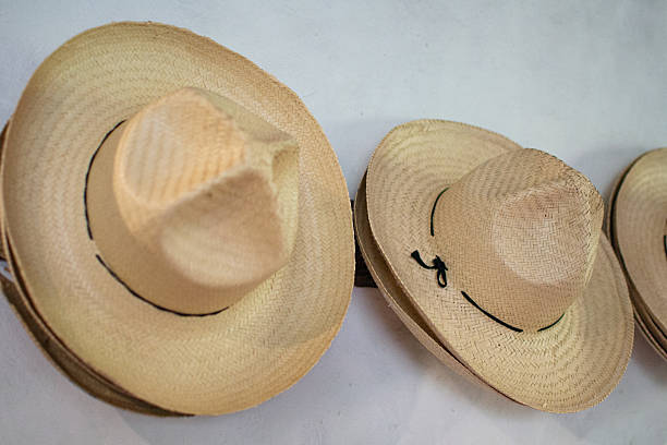 istock Traditional straw hats hanging on a white wall 2248466019