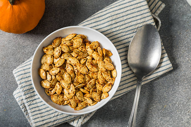 Roasted Homemade Spicy Pumpkin Seeds in a Bowl with Chili Powder