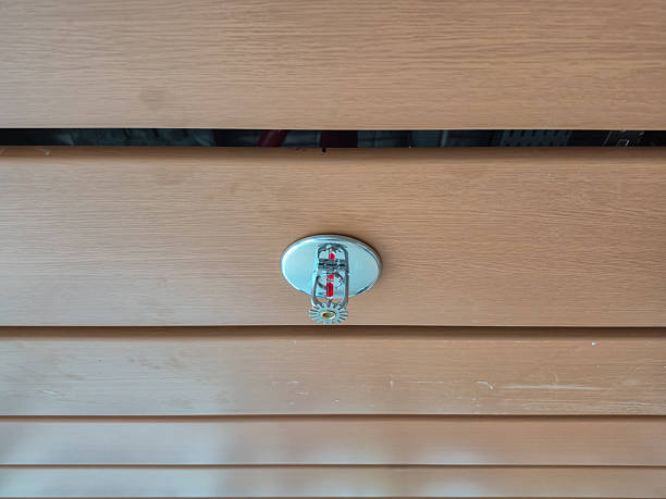 istock Recessed fire sprinkler head with red bulb on a white ceiling, essential safety equipment 2248466479