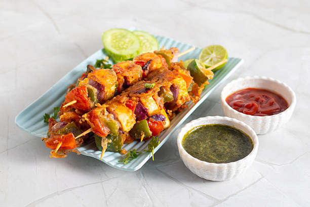 istock Paneer satay is a grilled Indian appetizer made with marinated paneer cubes, skewered, and served with spicy peanut or yogurt dip. 2248466782
