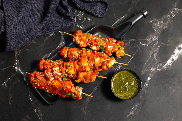 istock Paneer satay is a grilled Indian appetizer made with marinated paneer cubes, skewered, and served with spicy peanut or yogurt dip. 2248466803