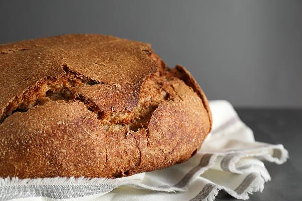istock Freshly baked sourdough bread on table against grey background, closeup. Space for text 2248468306